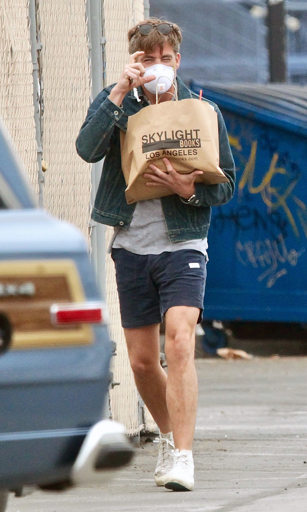 the same photo, there is a dumpster behind him