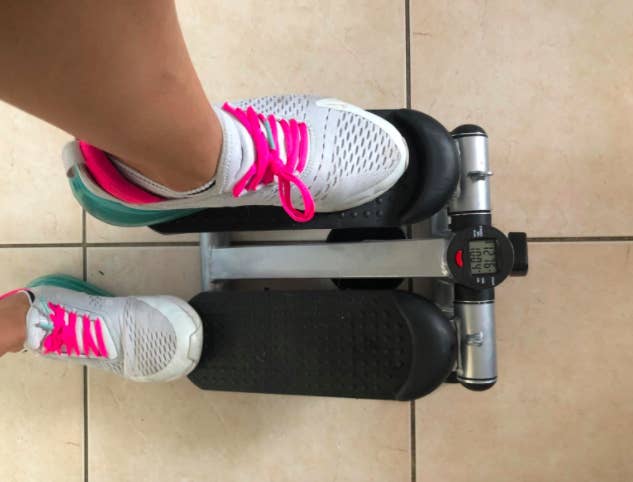 Reviewer exercises on black adjustable stepping machine