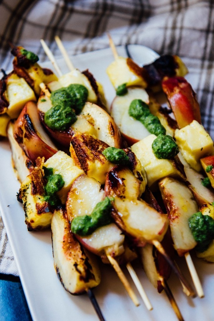 Skewers of grilled peaches and haloumi cheese drizzled with a basil yogurt dressing.
