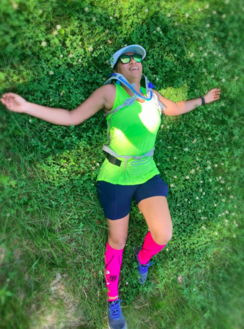 Reviewer wears lime green ventilated tank top after completing a running race