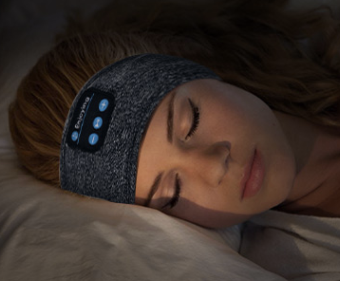 A model sleeping with the headphone band around her ears 