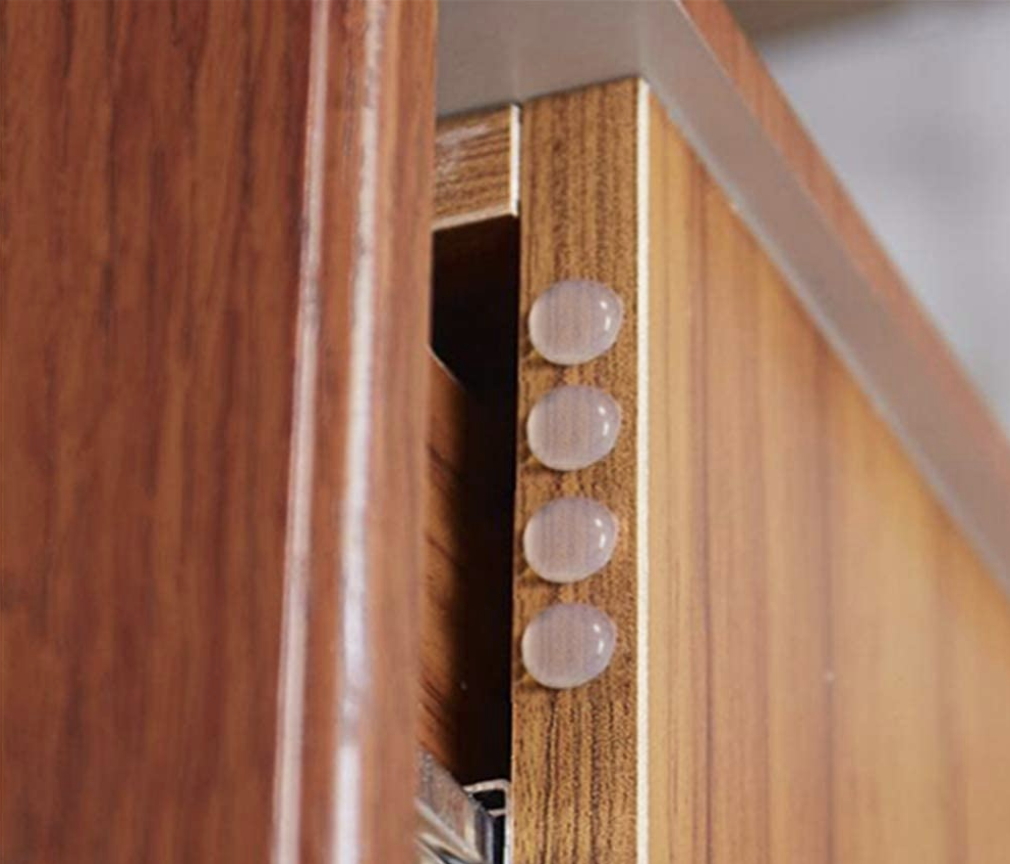 A set of four transparent penny-sized door bumpers