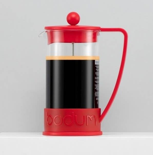 A mini French press filled with coffee