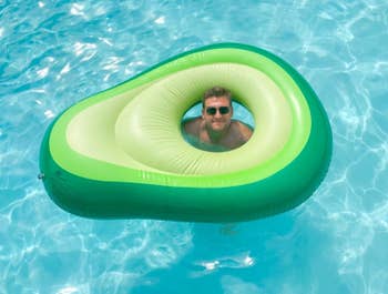 The avocado float in the pool with a reviewer's head through the hole