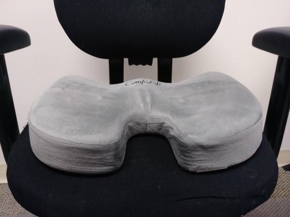 Reviewer&#x27;s swivel office chair with a memory foam cushion resting on it 