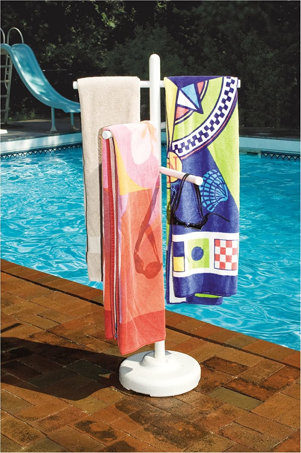 The rack holding three towels by a pool