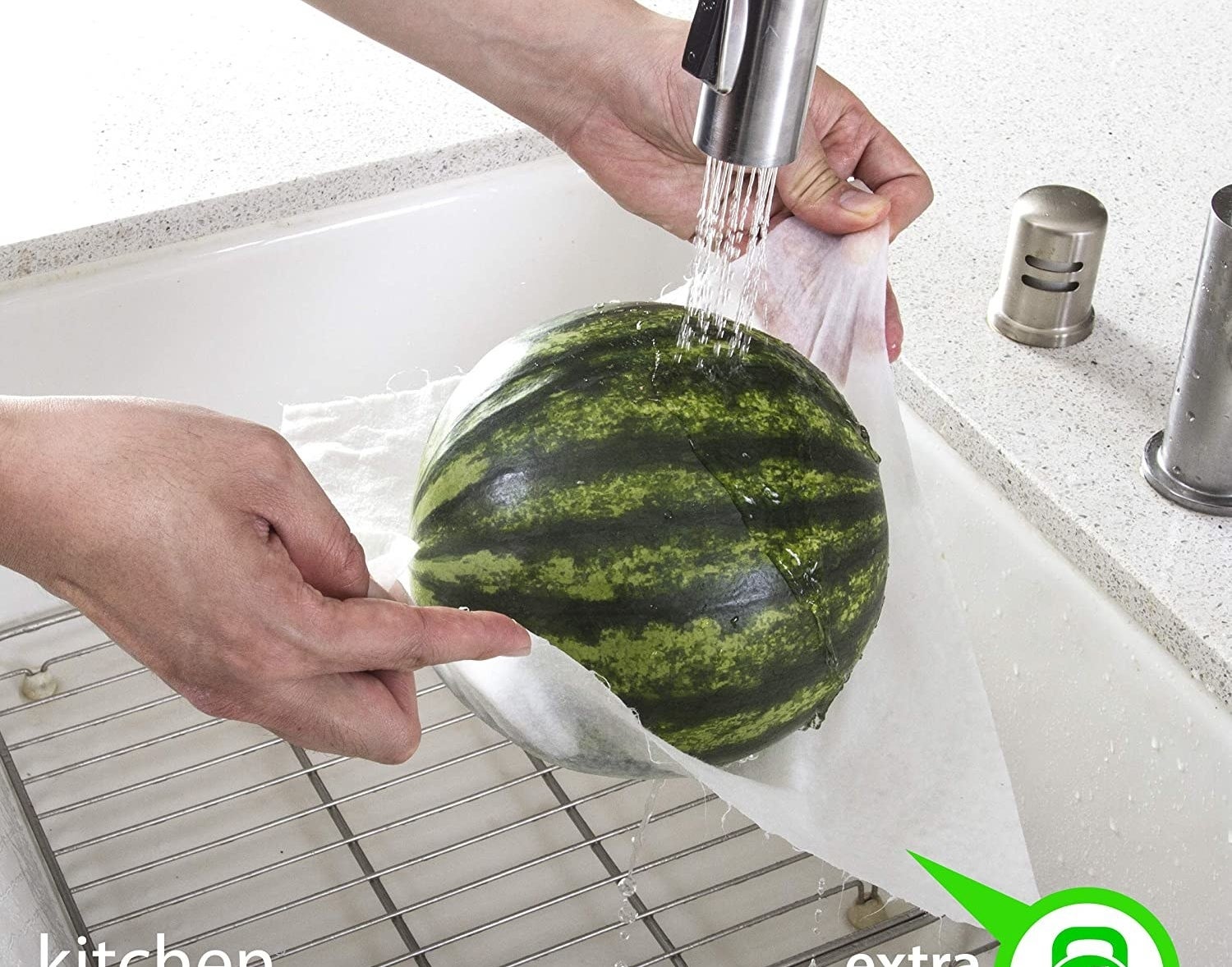 model washes a watermelon while holding it up with wet paper towel 