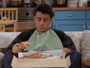 Joey from &quot;Friends&quot; eating pizza from a delivery box.