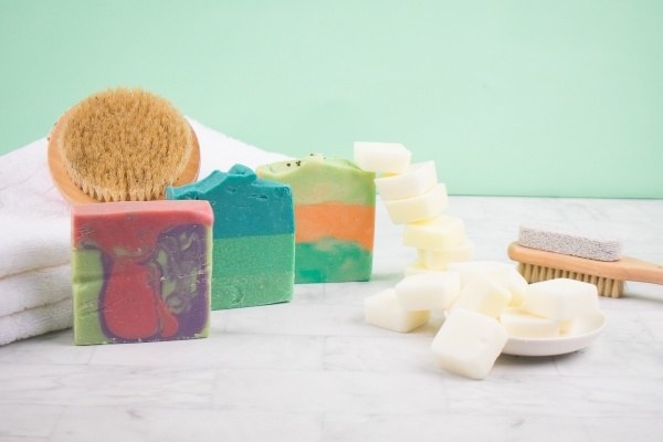 Three colorful soaps and a pile of wax melts 