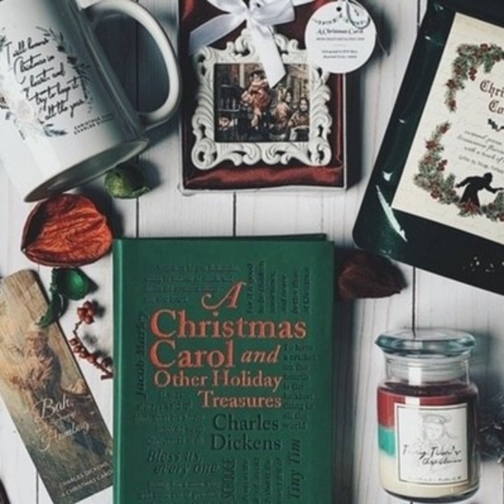 A spread of goodies from the Coffee and a Classic box, including a book, a mug, coffee, a bookmark, candle, and more