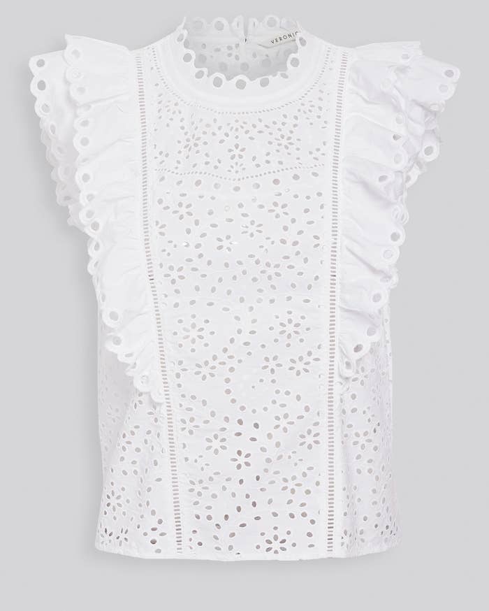 a white eyelet tank top with ruffled sleeves and collar