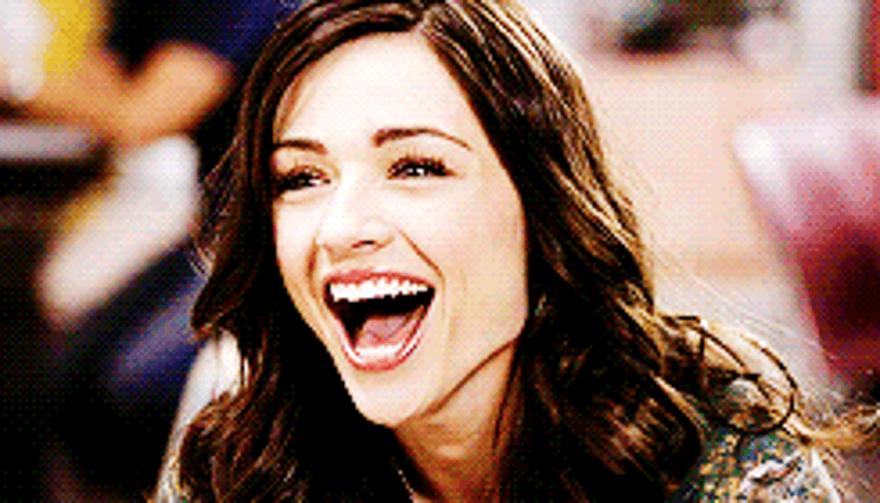 Gif of Allison Argent with a wide open-mouthed smile, looking pleased