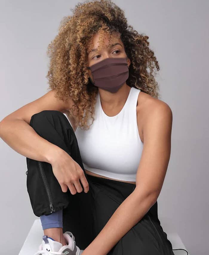 A model in athletic gear and a face mask
