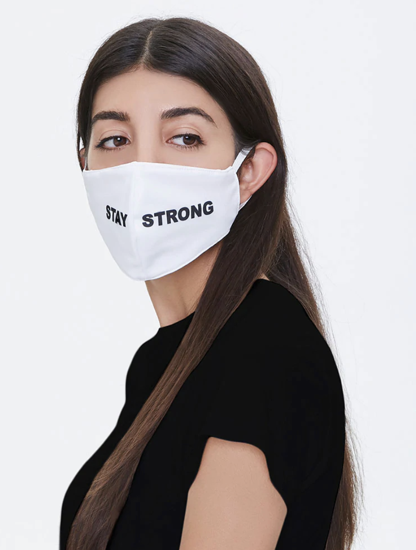 Model in a white mask that says "Stay Strong" in black letters