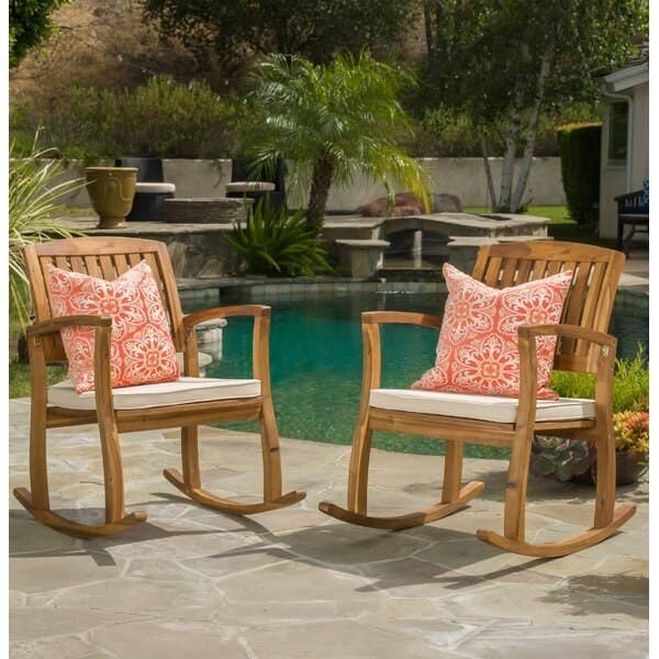 wood rocking chairs with a square seat cushion and floral throw pillows