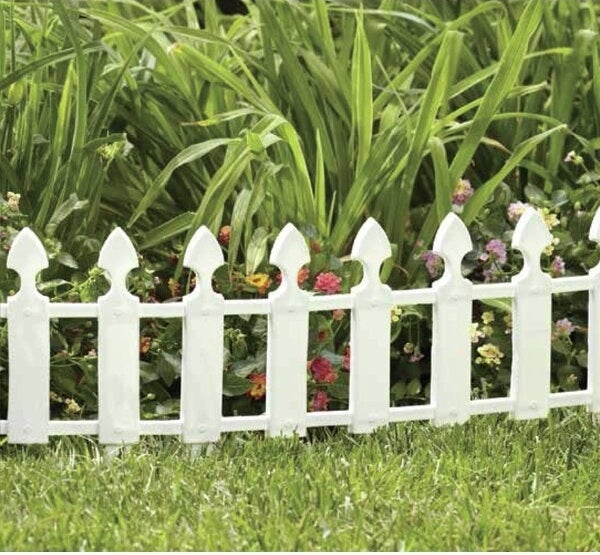 garden bed with short white picket fence style edging