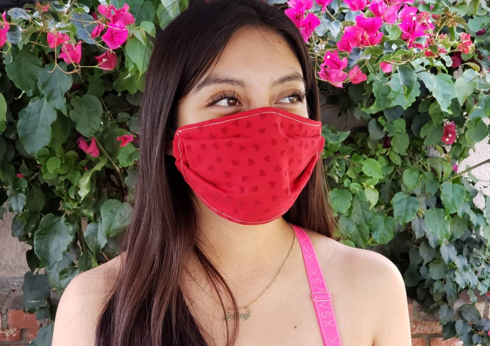 A model in a red heart-printed face mask