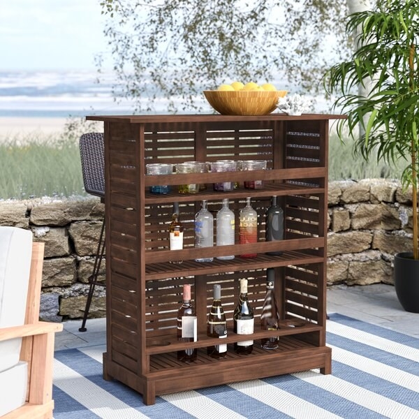 bookshelf-like outdoor bar with three shelves that have a bar to keep bottles in place
