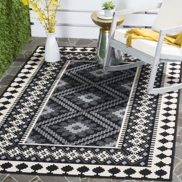 black and white graphic pattern rug on patio