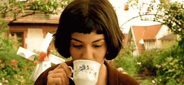Amelie drinking out of a teacup