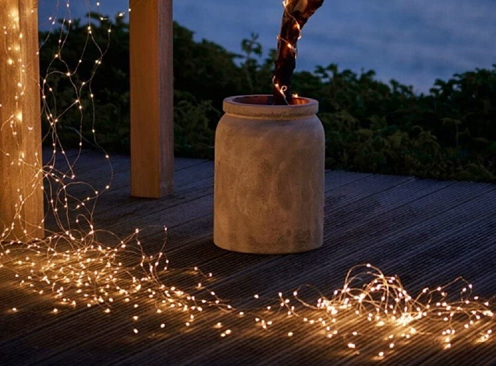Fairy lights draped across a deck in the evening