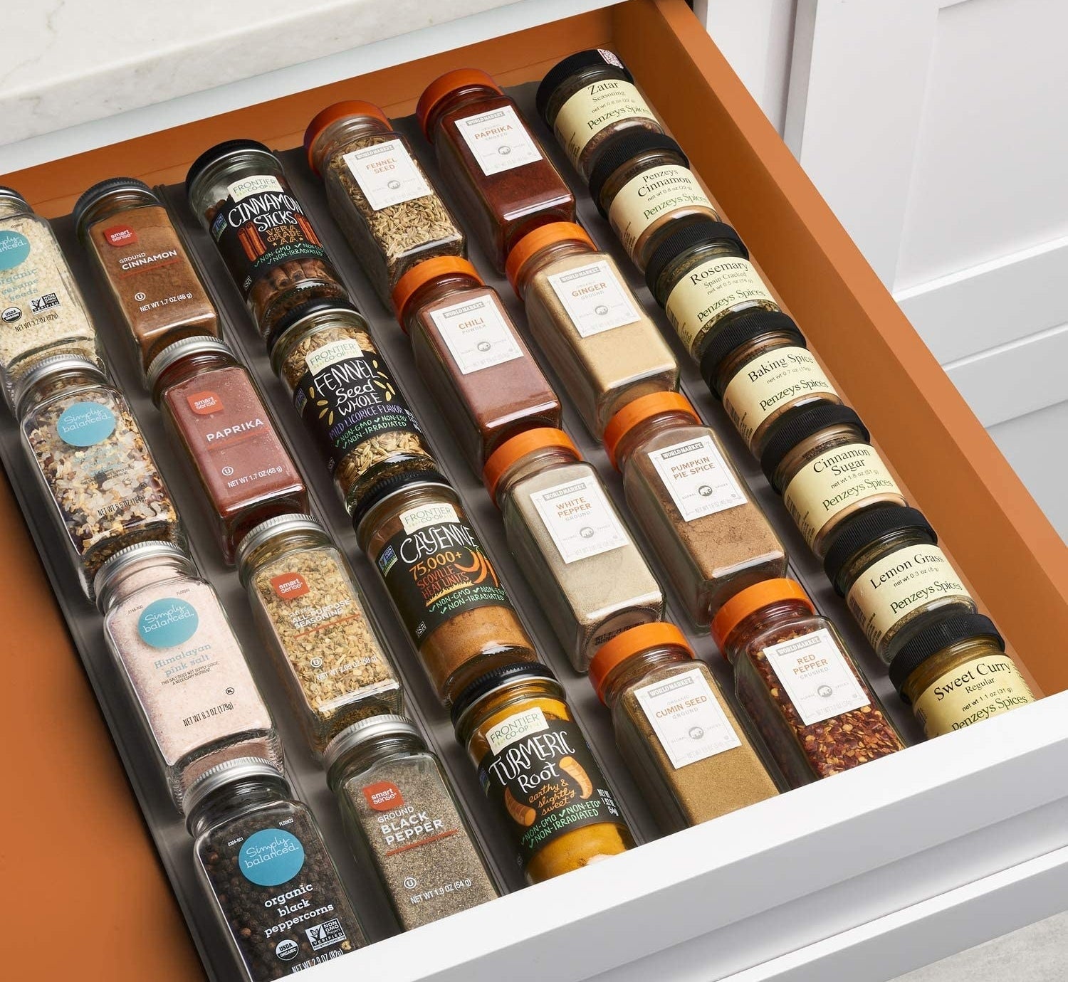 organizer inside of a drawer with various spices neatly aligned