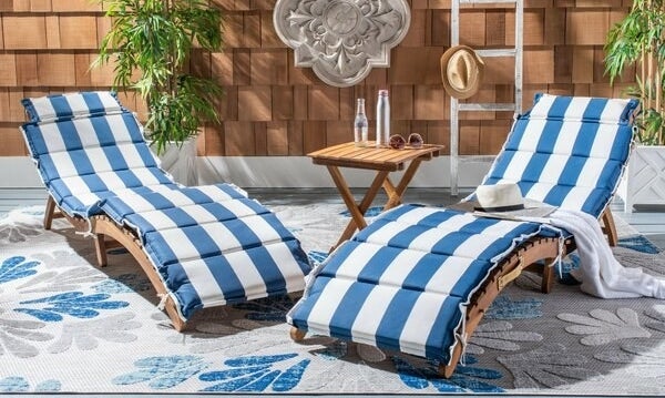 two wood chaise lounge chairs with blue and white cushions included, no arm rests