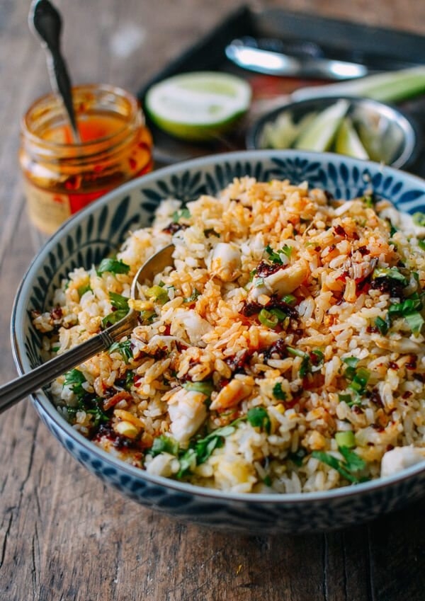 A big bowl of fried rice with chunks of crab meat. 