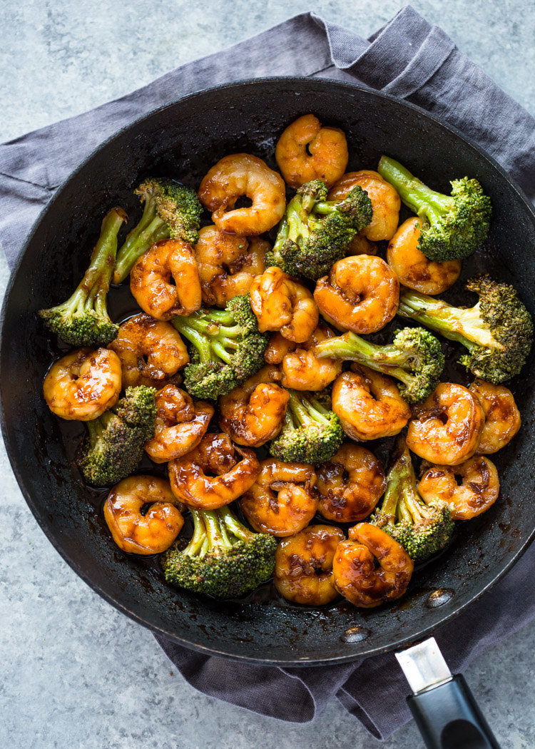 Stir fried shrimp and broccoli in a skillet.