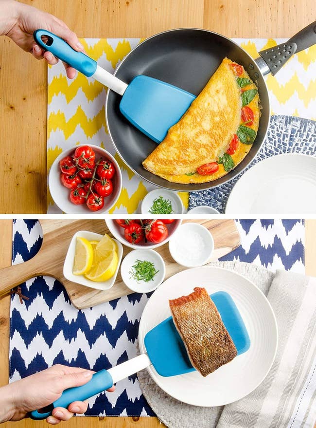 Hand using the blue extra-large spatula to flip an omelette and a piece of salmon 