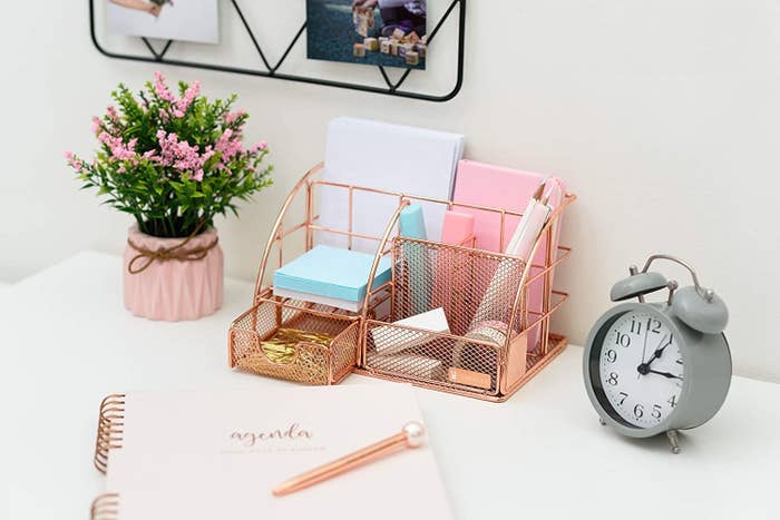 Desk organizer with pen and pencil holder, paper holder, small drawer, and three other compartments