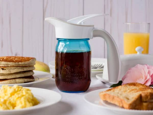 mason jar with liquid with the spout on top and large easy-to-grip handle