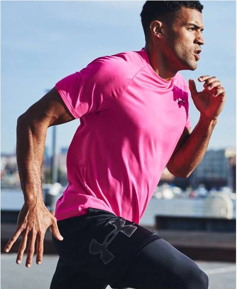 A model wearing a bright pink short-sleeve shirt while running