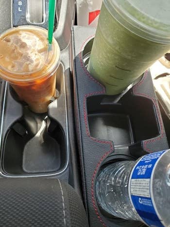 Another reviewer's picture of the console organizer holding a cup of Starbucks and a water
