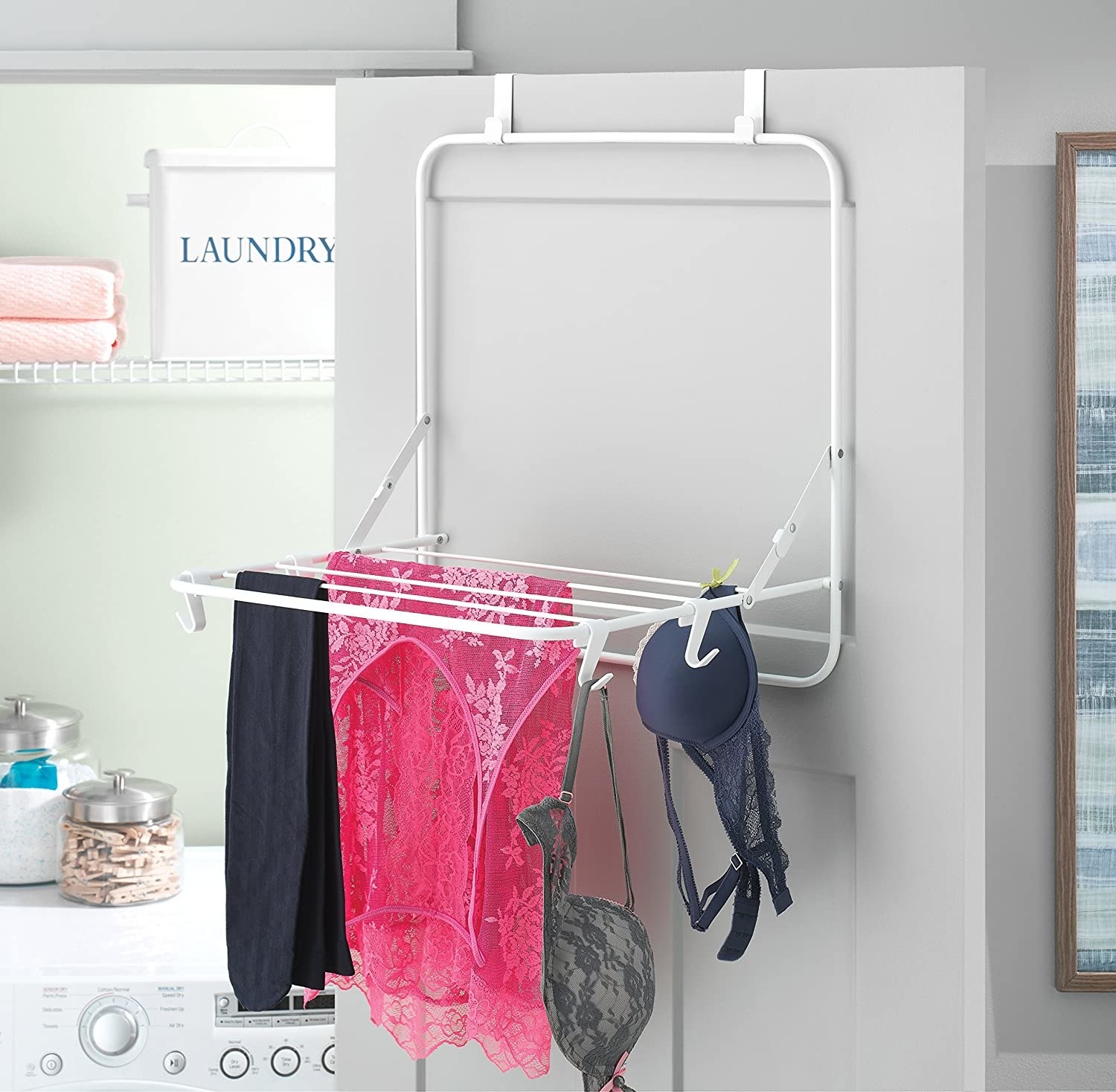 Bras, nighties, and yoga pants hanging from the over-the-door drying rack