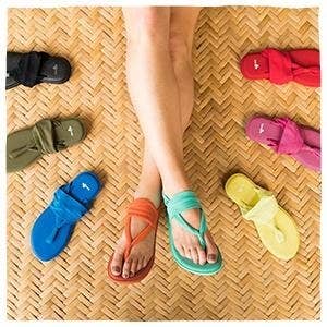 A model wearing different colored Sanuk sling sandals.