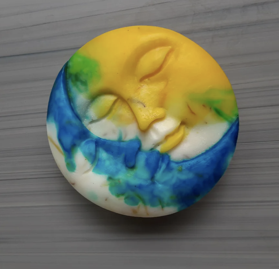 A yellow, blue, and white crescent and full moon hand soap bar 
