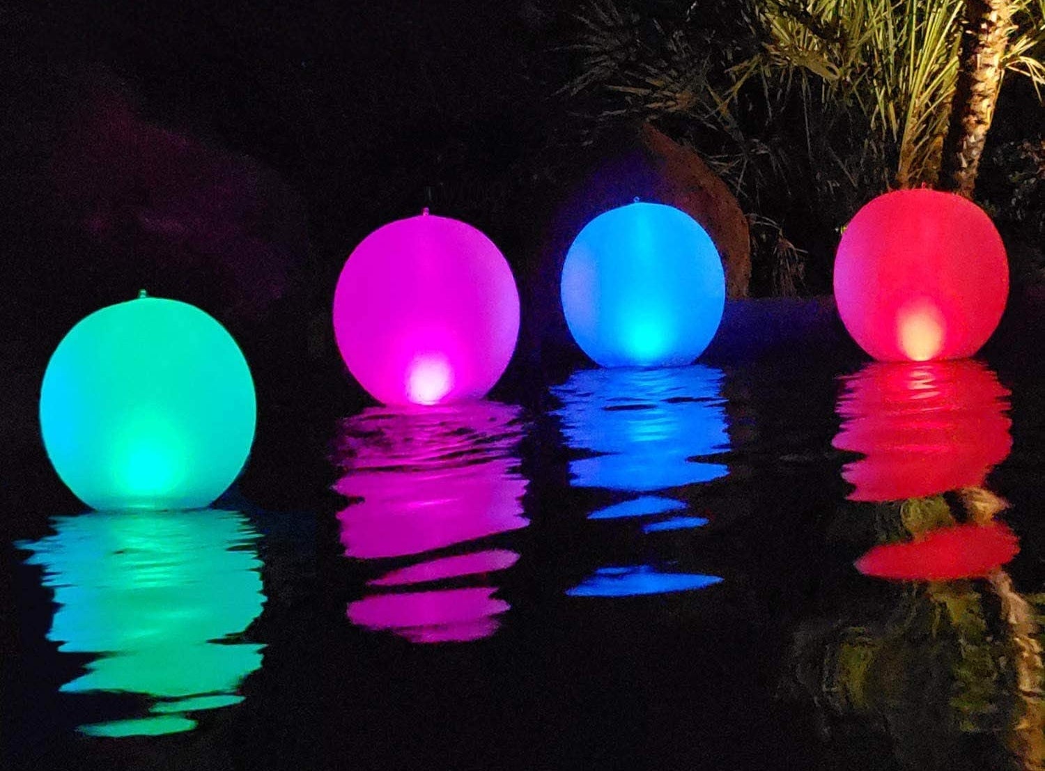 Four different-colored balls floating in the pool