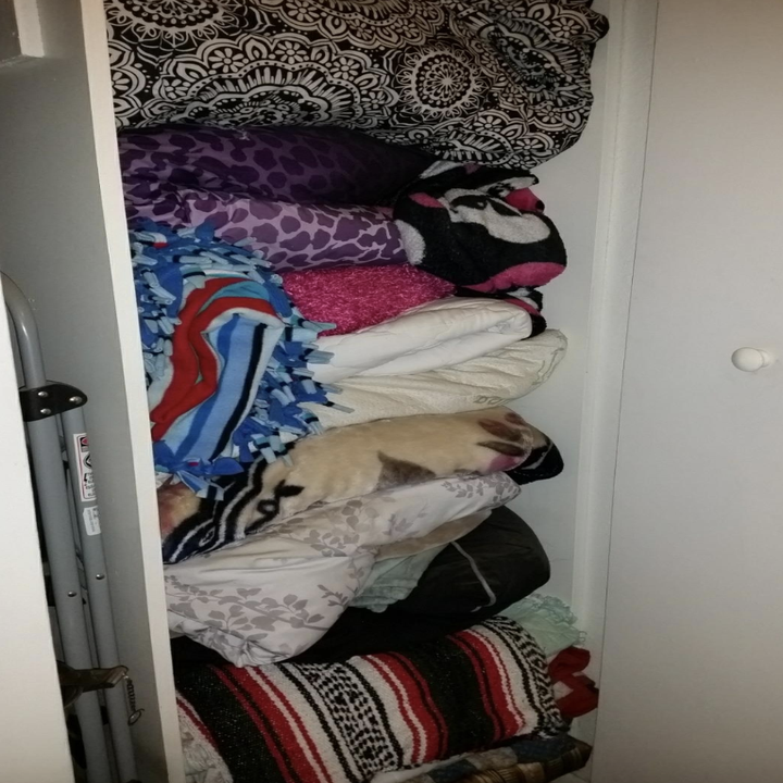 before review photo of closet packed with blankets 