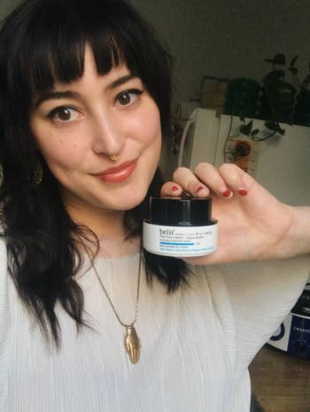 BuzzFeed Editor, Rachel Dunkel, holding a jar of Belief The True Cream Aqua Bomb