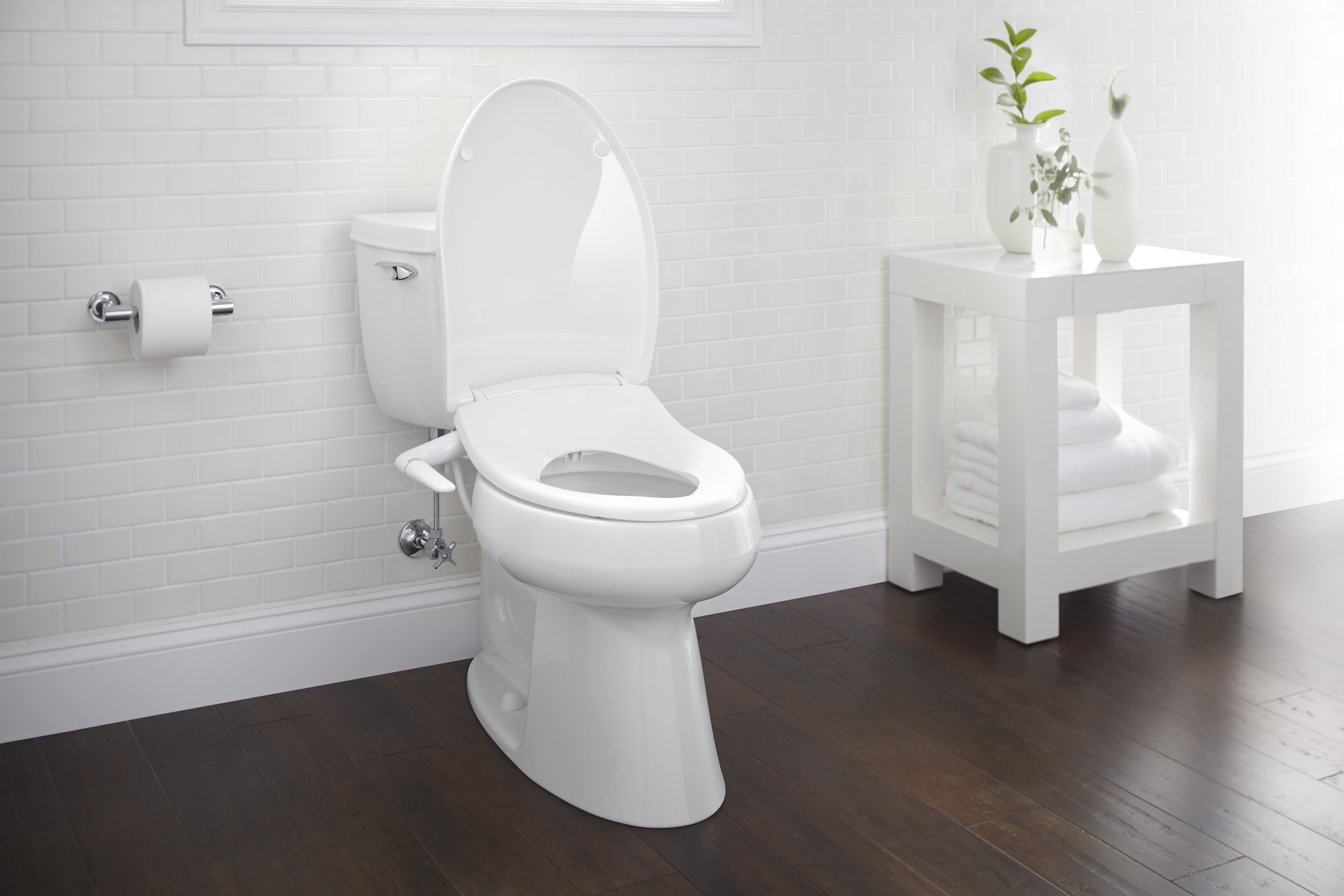 White toilet with bidet seat in bathroom