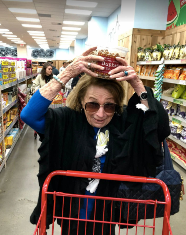 My grandmother at Trader Joe&#x27;s, showing off a package of &quot;dunkers&quot; cookies.