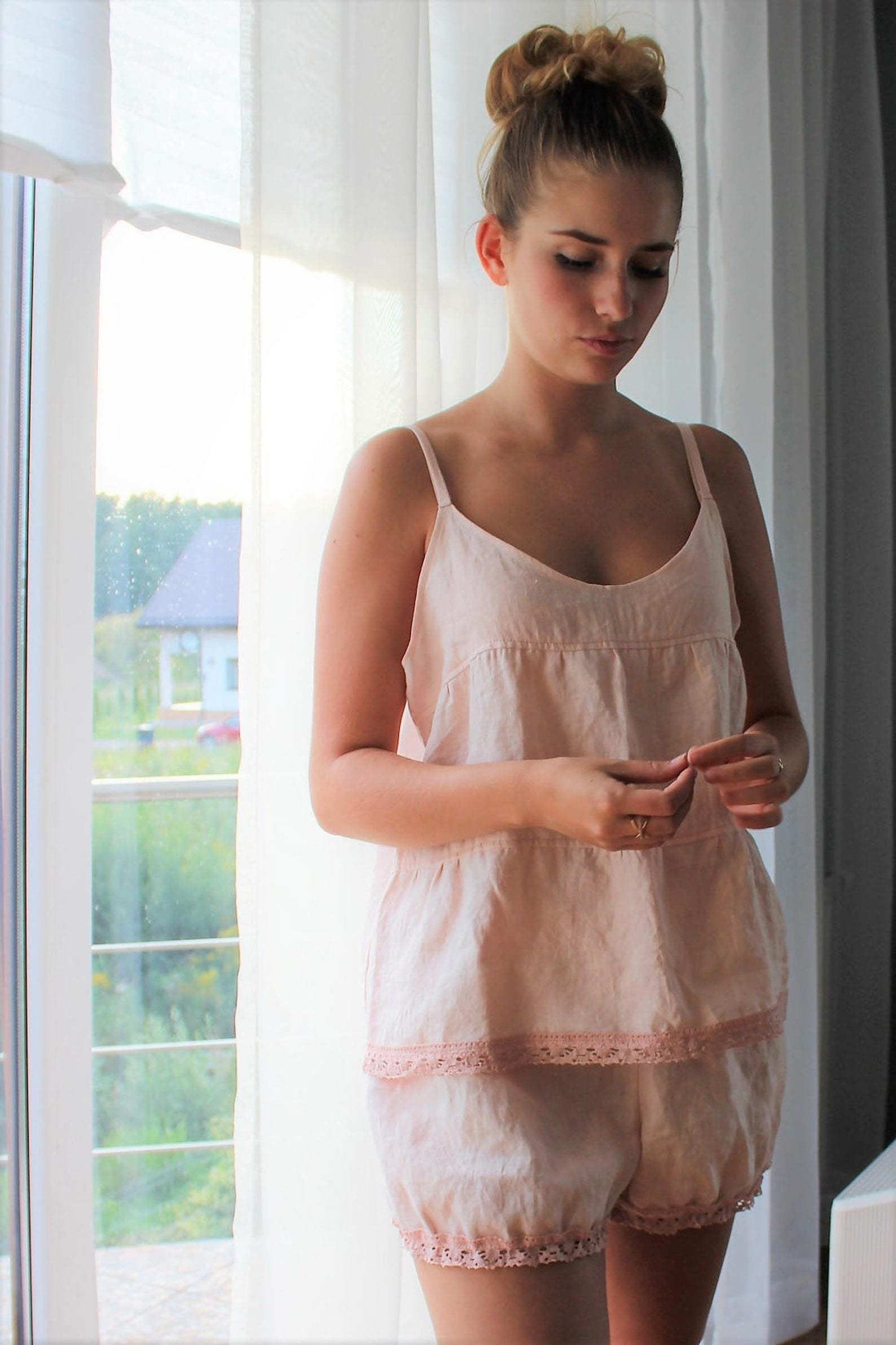 model in pink A-line tank with lace border and matching pantaloon-like shorts
