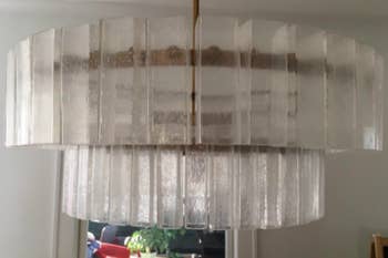 A reviewer's chandelier with large, cloudy glass panels 