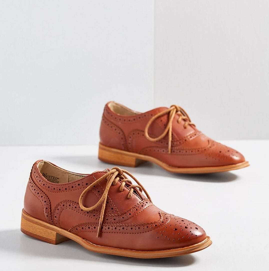those shoes in a chestnut brown color laced up in the front and with detailed perforations throughout
