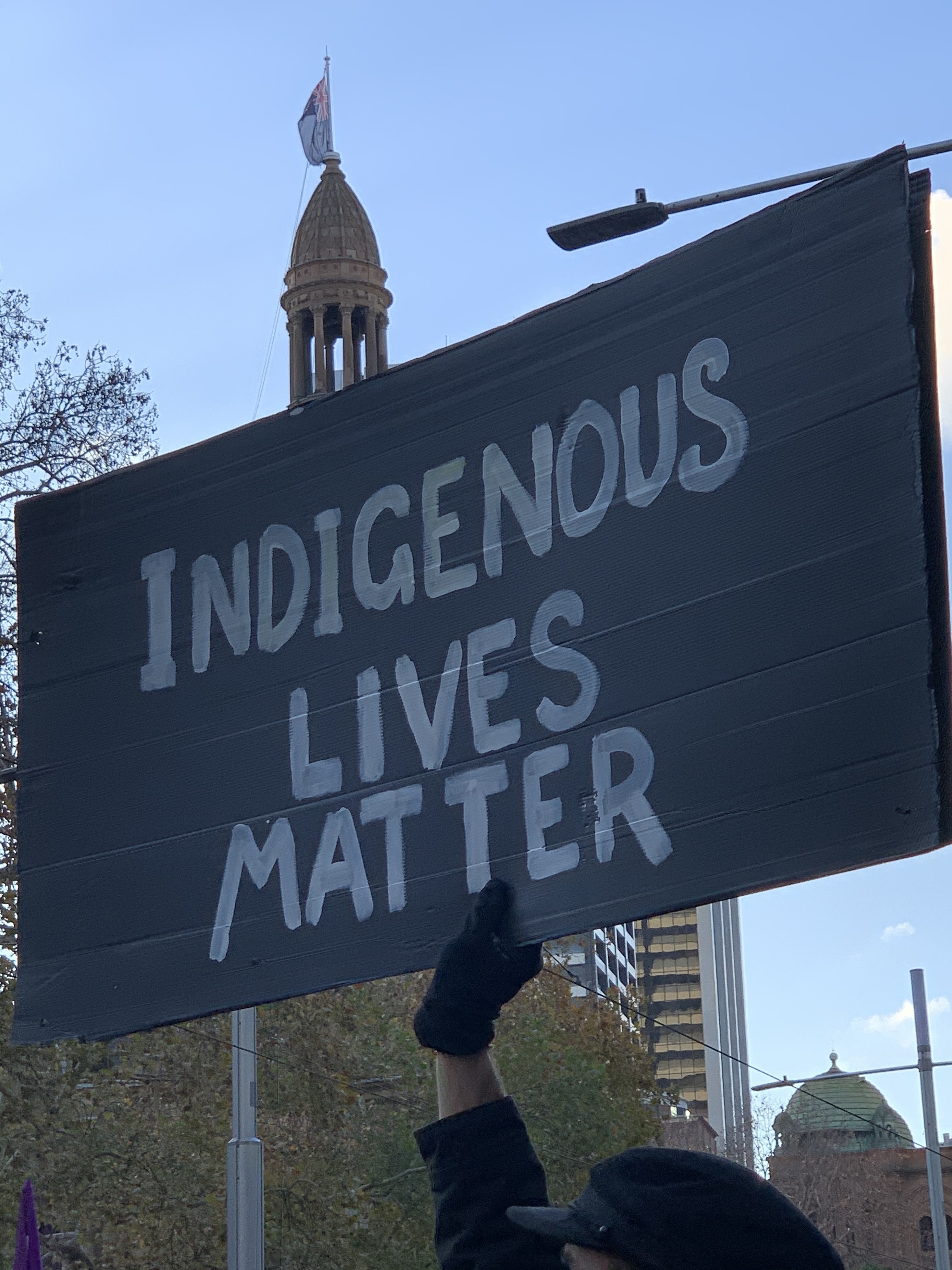 A protest sign reads &quot;Indigenous lives matter&quot;.