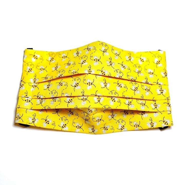 yellow nonmedical mask with bee pattern