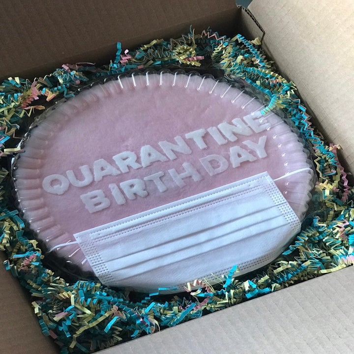 cotton candy layer cake with "quarantine birthday" on it with a face mask