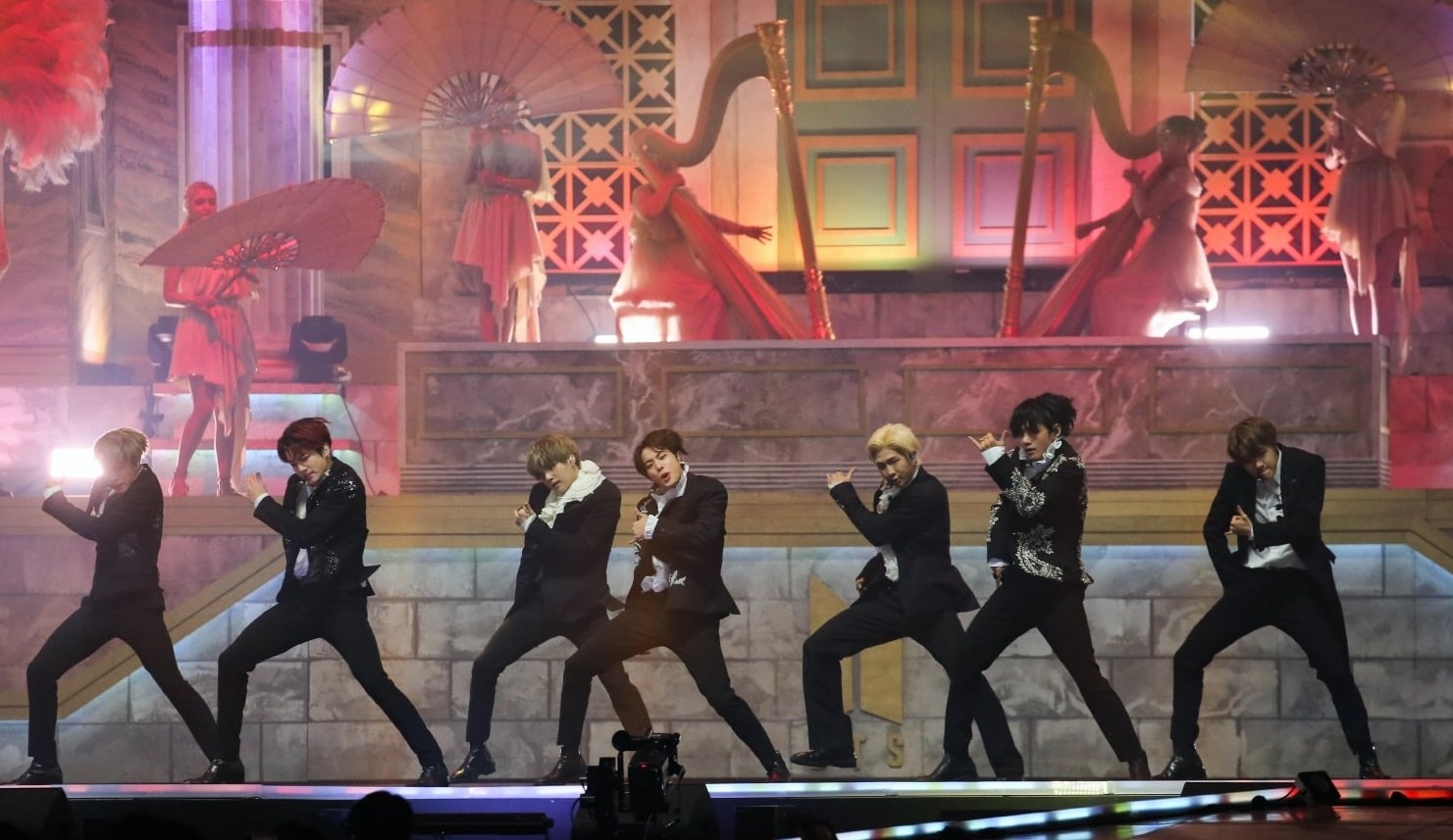 BTS performs in suits on a stage designed to look like a temple