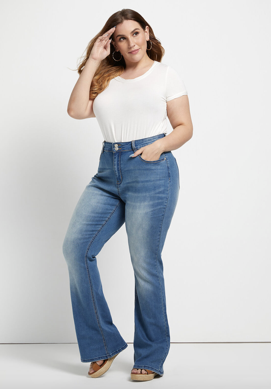 A model in medium wash, faded jeans 
